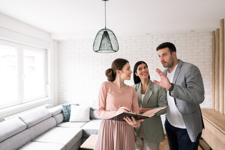 A young couple asking questions to a real estate attorney